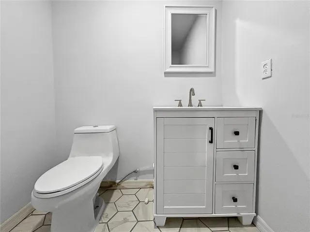 a kitchen with a refrigerator and a stove top oven