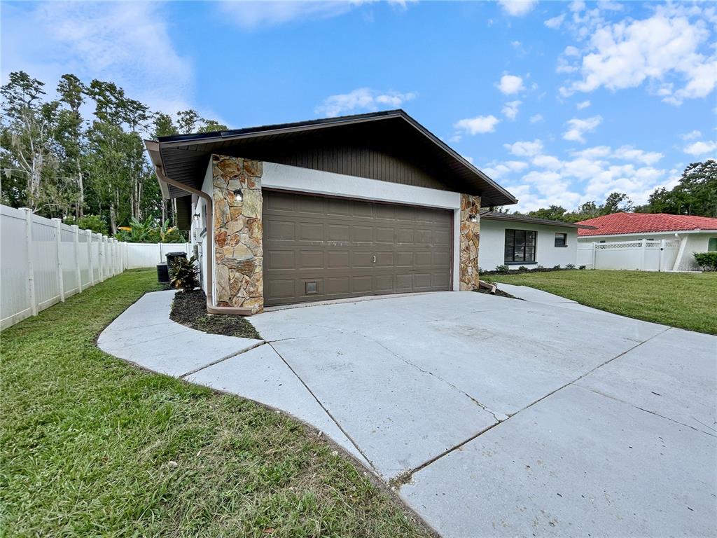 4545 Debbie Lane Lutz, FL 33559 - Photo 2 of 25 a front view of a house with a yard