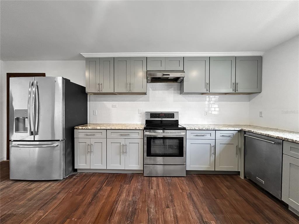 4545 Debbie Lane Lutz, FL 33559 - Photo 21 of 25 a kitchen with a refrigerator and a stove top oven