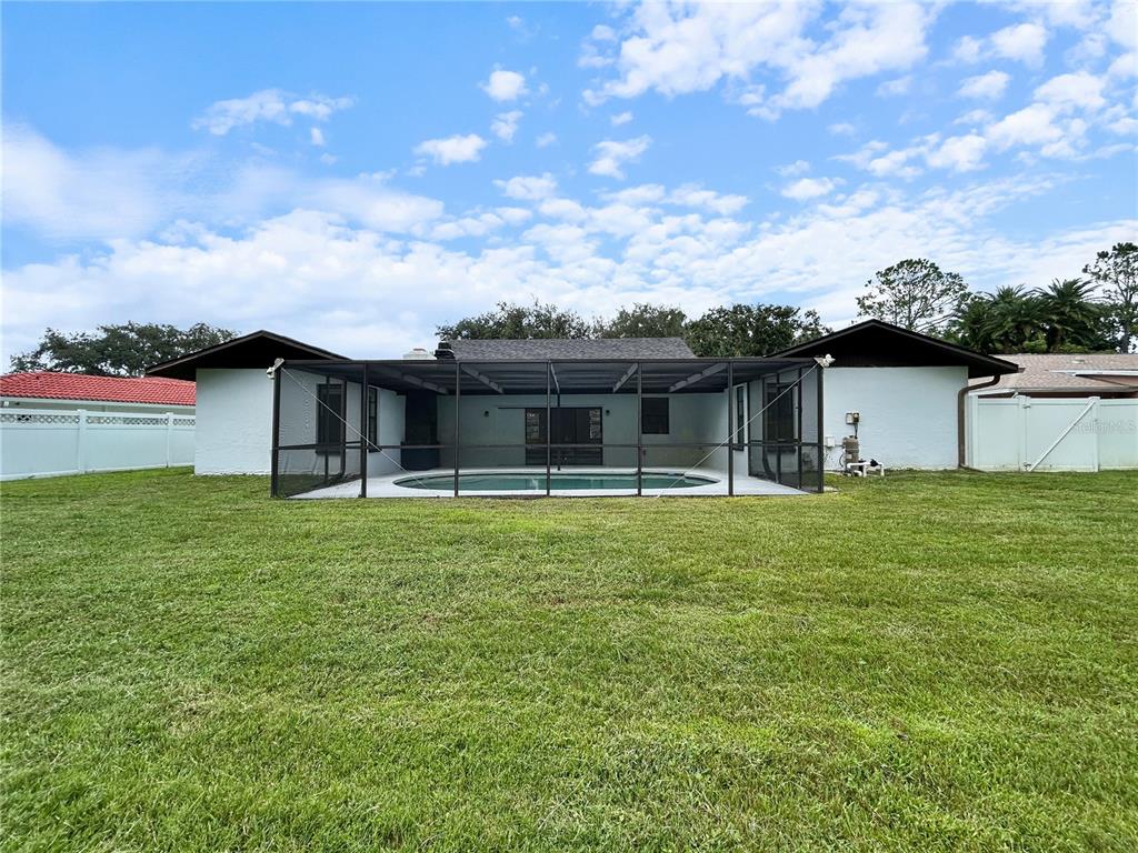 4545 Debbie Lane Lutz, FL 33559 - Photo 24 of 25 a view of a house with a backyard