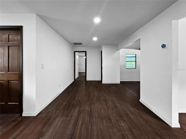 a view of a room with wooden floor and window