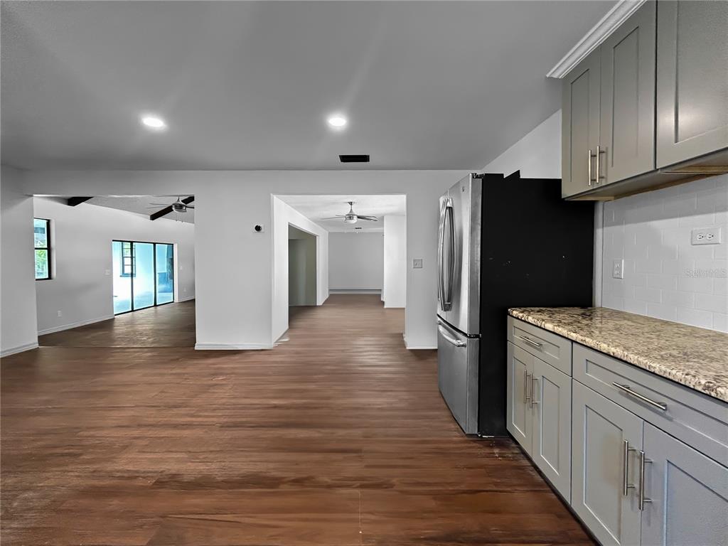 4545 Debbie Lane Lutz, FL 33559 - Photo 10 of 25 a kitchen with stainless steel appliances granite countertop a refrigerator and a stove