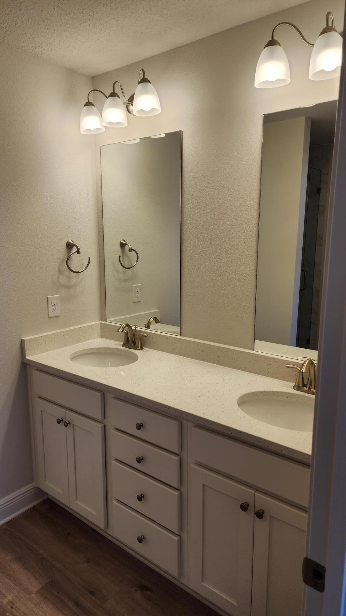 4 Renea Cove Destin, FL 32541 - Photo 7 of 12 a bathroom with a double vanity sink and a mirror
