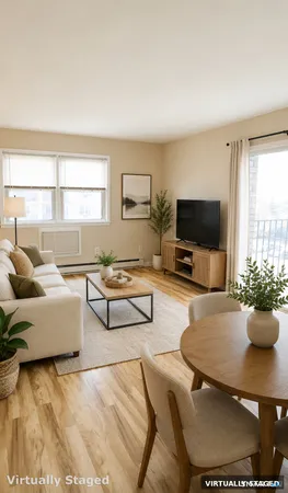 a living room with furniture a flat screen tv and a window
