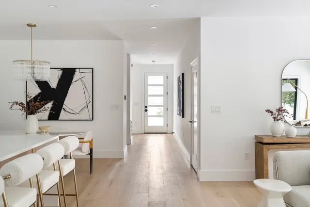 a view of a hallway with entryway wooden floor and front door