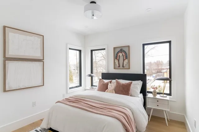 a bedroom with a large bed and a window