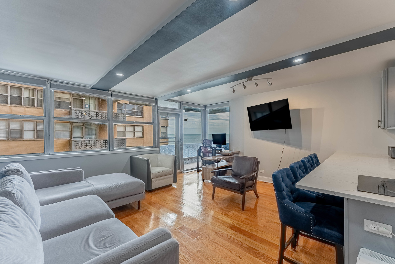 6301 North Sheridan Road, Unit 7F Chicago, IL 60660 - Photo 2 of 15 a living room with furniture and a flat screen tv