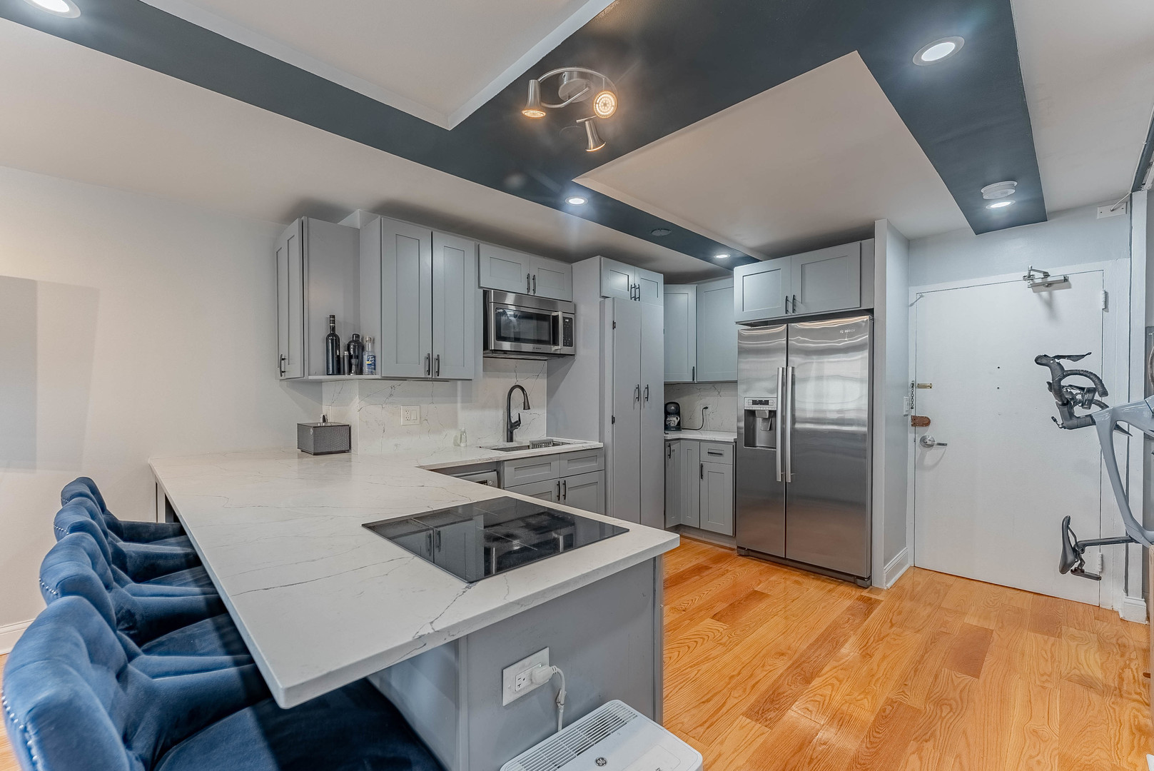 6301 North Sheridan Road, Unit 7F Chicago, IL 60660 - Photo 4 of 15 a kitchen with stainless steel appliances granite countertop a sink refrigerator and cabinets