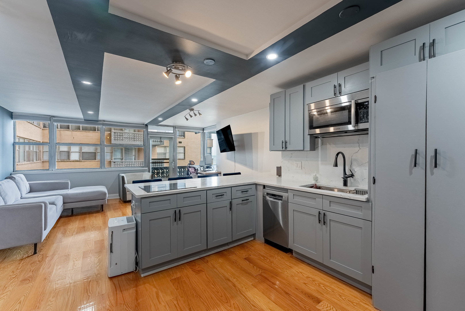 6301 North Sheridan Road, Unit 7F Chicago, IL 60660 - Photo 5 of 15 a kitchen with stainless steel appliances granite countertop a sink and stove top oven
