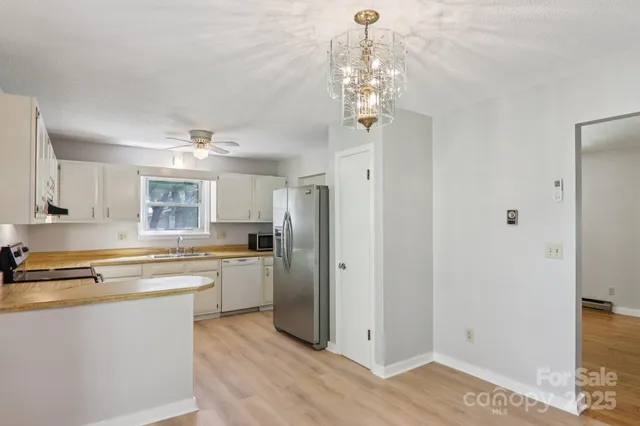 a kitchen with stainless steel appliances granite countertop a refrigerator and a stove top oven