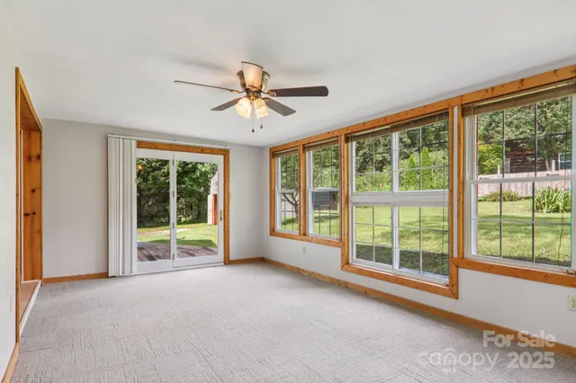 a view of room with window and a ceiling fan