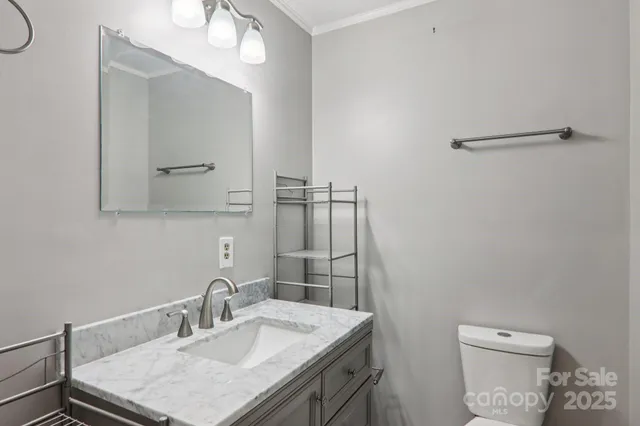 a bathroom with a sink toilet and mirror