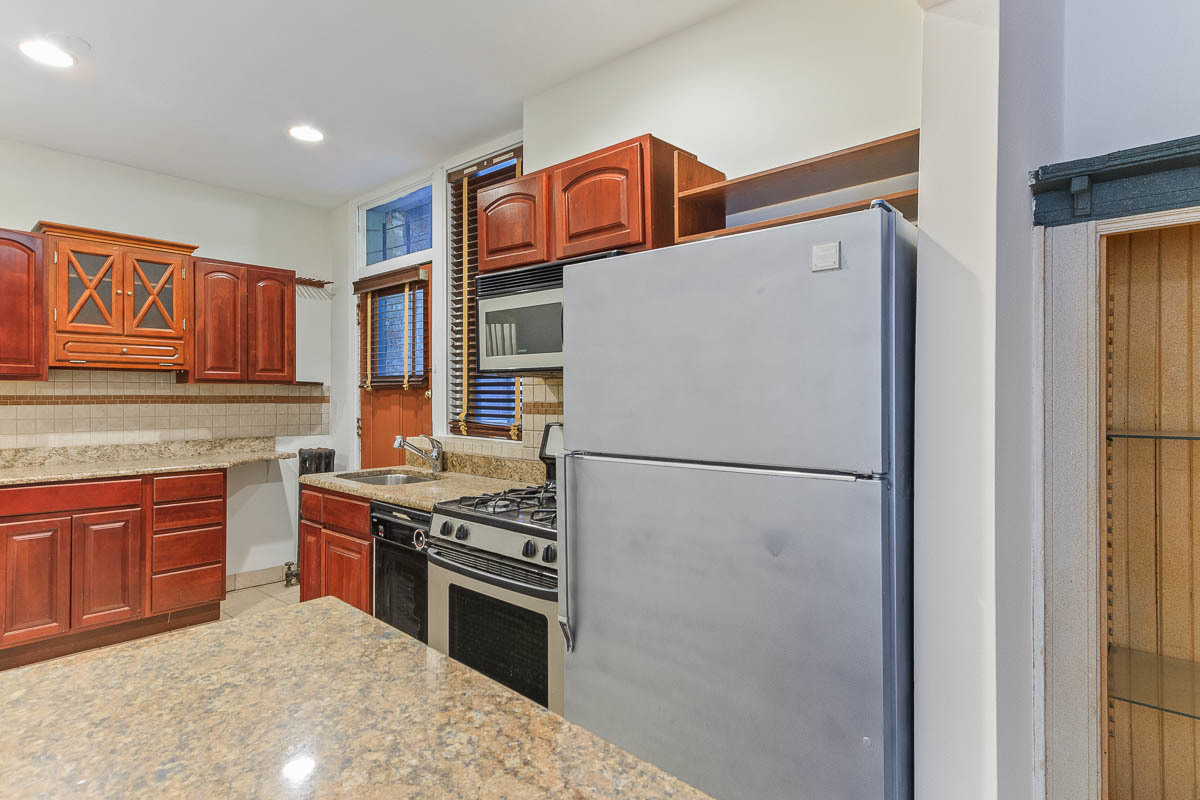 601 West Fullerton Avenue, Unit 1 Chicago, IL 60614 - Photo 11 of 25 a kitchen with stainless steel appliances granite countertop a refrigerator a stove a sink and a microwave