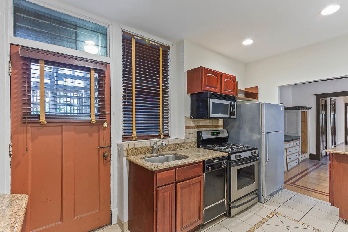 601 West Fullerton Avenue, Unit 1 Chicago, IL 60614 - Photo 12 of 25 a kitchen with stainless steel appliances granite countertop a stove and a refrigerator