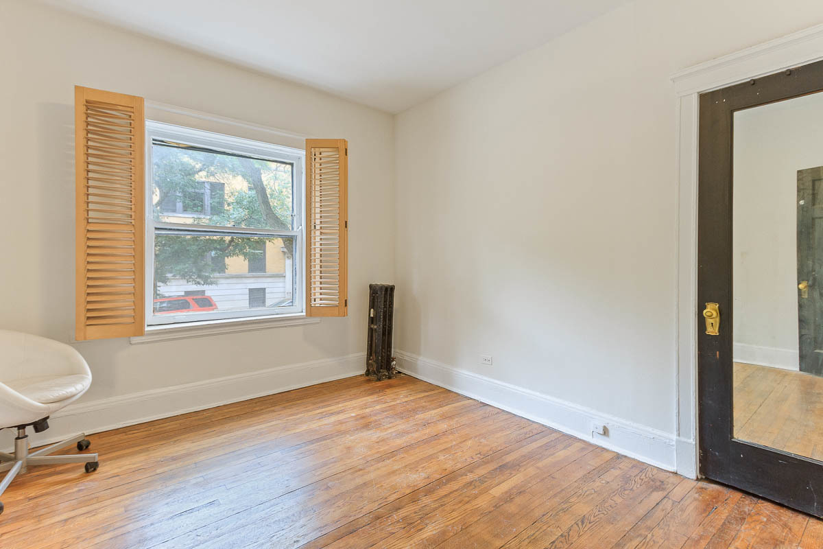 601 West Fullerton Avenue, Unit 1 Chicago, IL 60614 - Photo 19 of 25 a view of an empty room with a window and wooden floor
