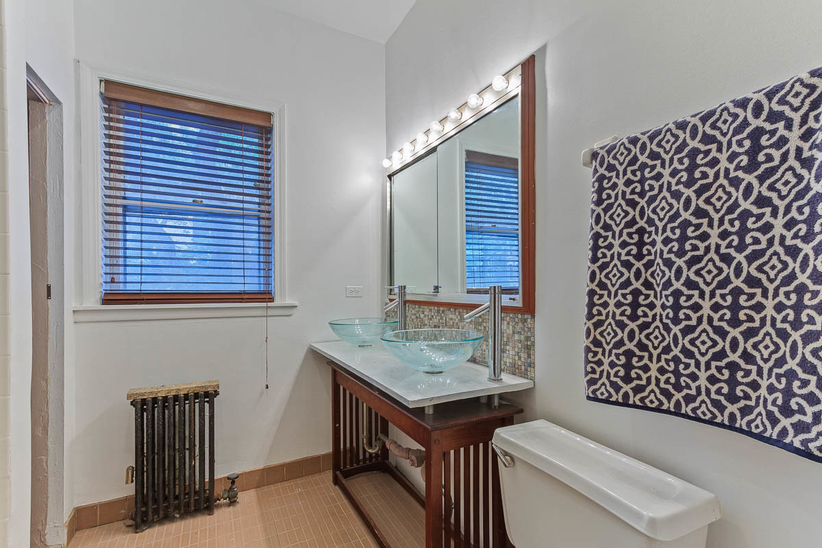 601 West Fullerton Avenue, Unit 1 Chicago, IL 60614 - Photo 21 of 25 a bathroom with a granite countertop sink and a toilet