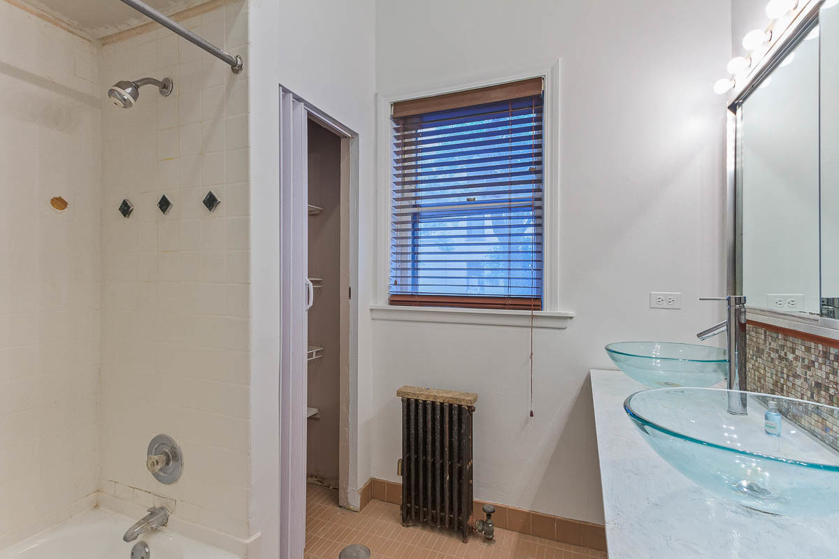 601 West Fullerton Avenue, Unit 1 Chicago, IL 60614 - Photo 22 of 25 a bathroom with a sink and a mirror