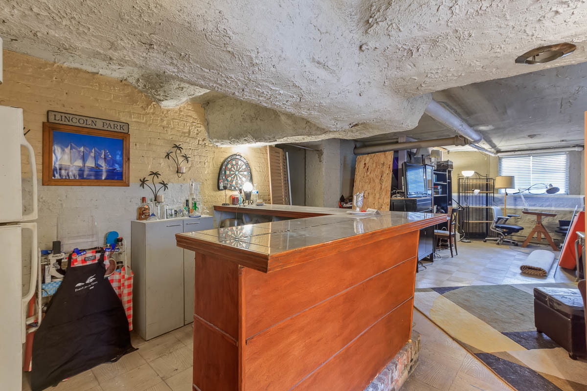 601 West Fullerton Avenue, Unit 1 Chicago, IL 60614 - Photo 25 of 25 a view of a kitchen with kitchen island stainless steel appliances wooden floor and large windows