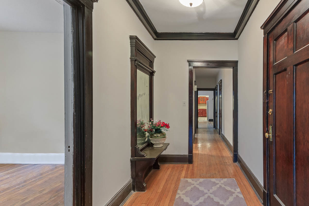 601 West Fullerton Avenue, Unit 1 Chicago, IL 60614 - Photo 8 of 25 a hallway with wooden floor and a potted plant