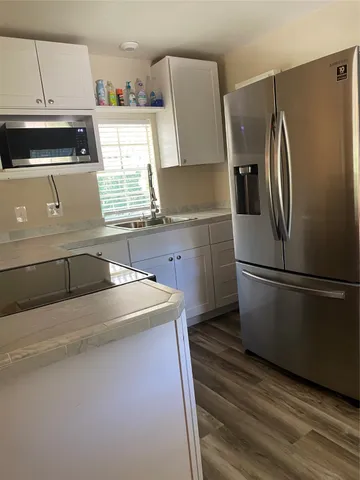 a room with wooden floor and an empty room