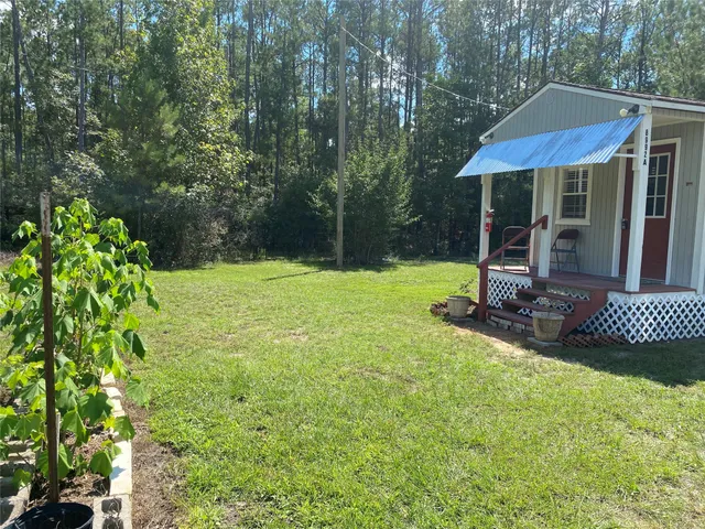 a view of backyard with a garden and outdoor seating