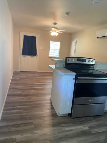a room with wooden floor and an empty room