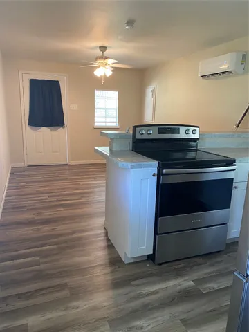 a view of kitchen cabinets and wooden floor
