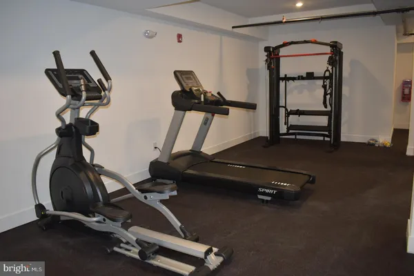 a room with gym equipment and white walls