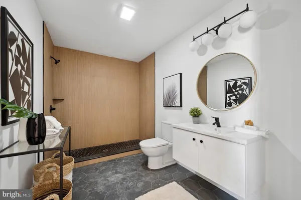 a bathroom with a toilet sink and mirror