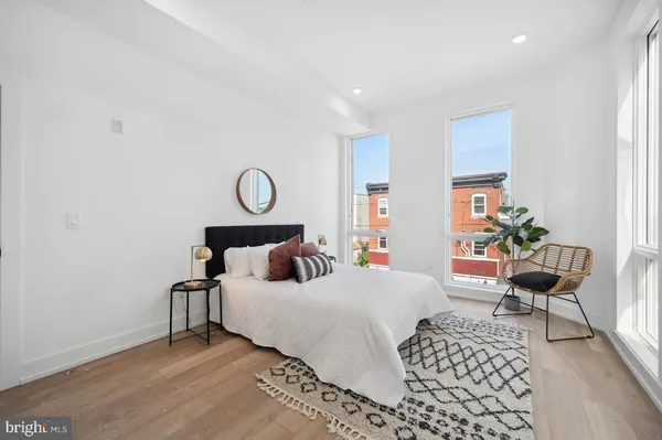 a bed room with a bed and a chair