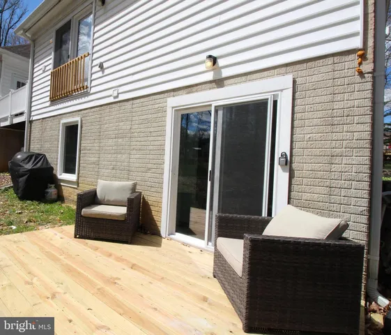 a backyard of a house with sofas