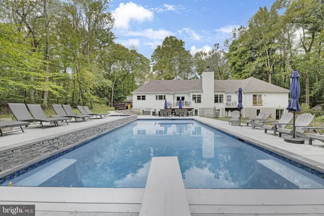 a view of a swimming pool with lounge chair