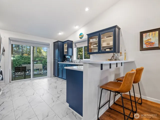 a kitchen with stainless steel appliances granite countertop a refrigerator and a stove