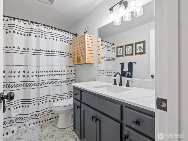 a bedroom with a bed and a desk