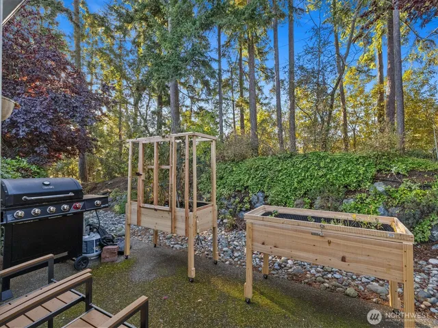 a backyard of a house with yard barbeque oven and outdoor seating