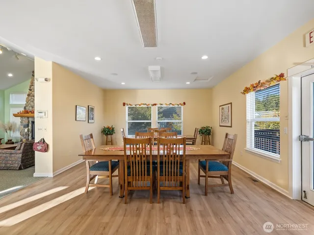 a room with pool table and windows