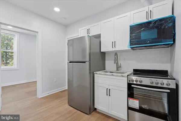 a kitchen with a stove microwave and refrigerator