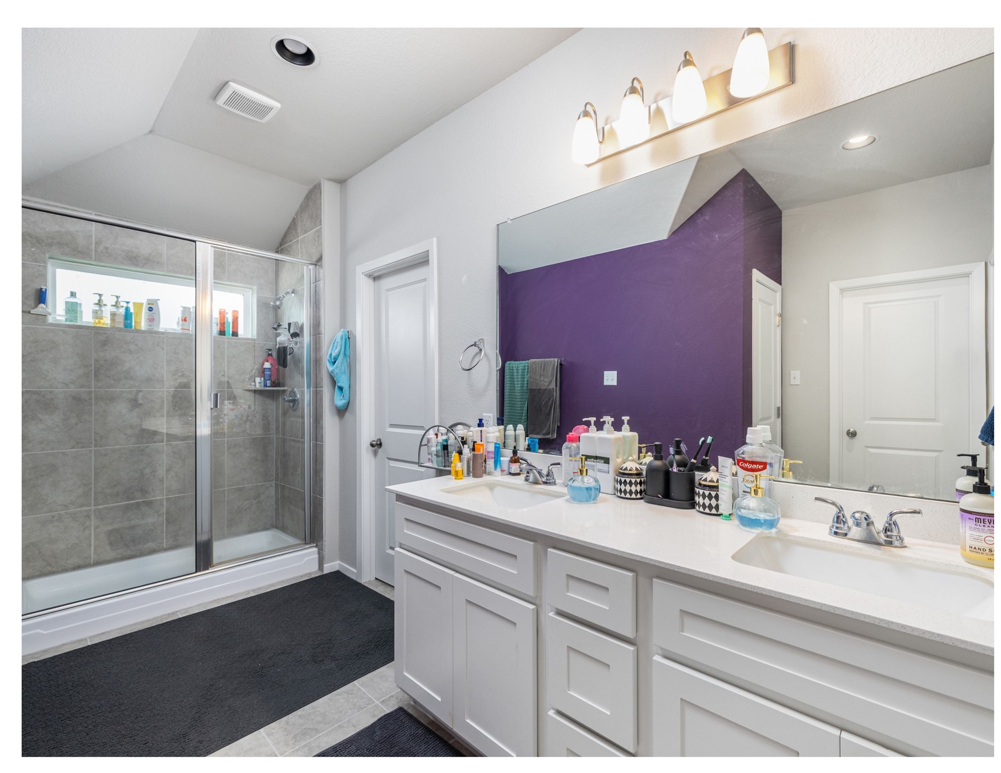 121 Graver Street Georgetown, TX 78626 - Photo 13 of 28 Double vanity and a spacious shower create a highly functional primary bathroom retreat.