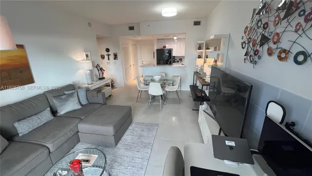 a living room with furniture and a mirror