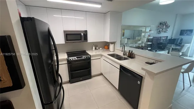 a kitchen with a sink appliances and cabinets