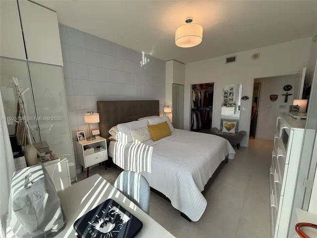 a bedroom with a bed window and a couch