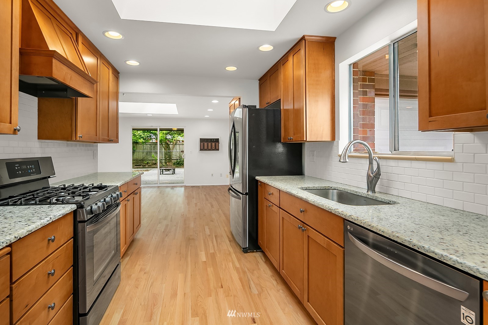 408 Index Place Northeast Renton, WA 98056 - Photo 11 of 31 a kitchen with stainless steel appliances granite countertop sink stove and refrigerator