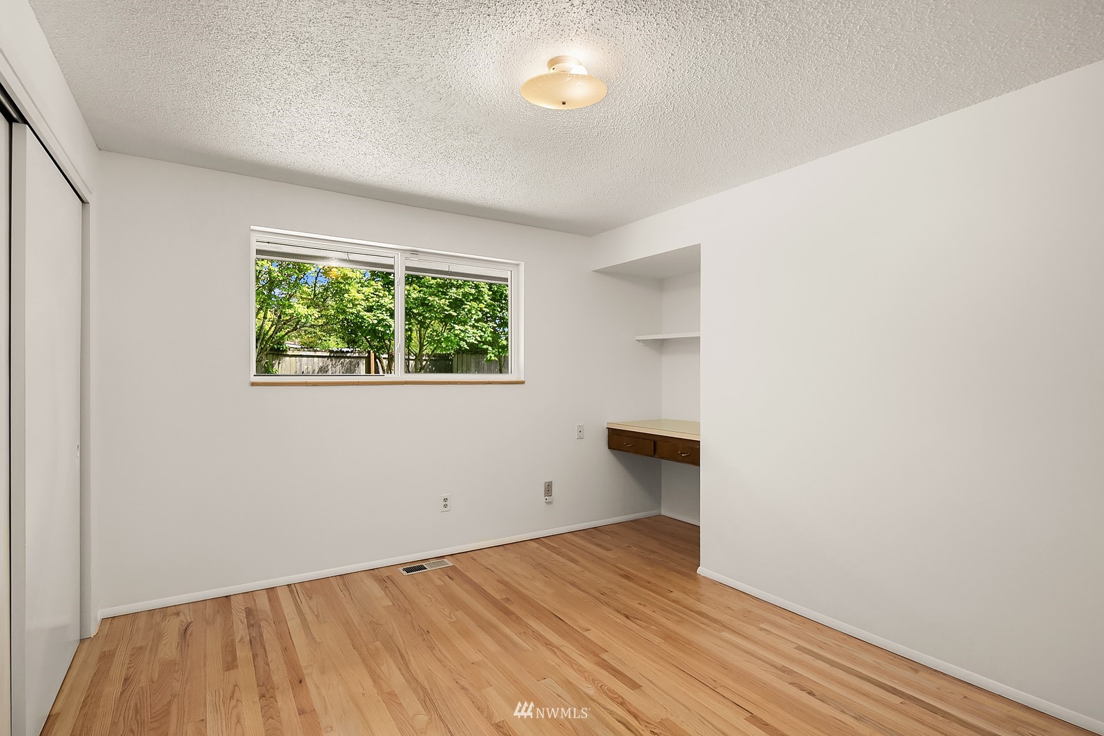 408 Index Place Northeast Renton, WA 98056 - Photo 20 of 31 an empty room with wooden floor and windows