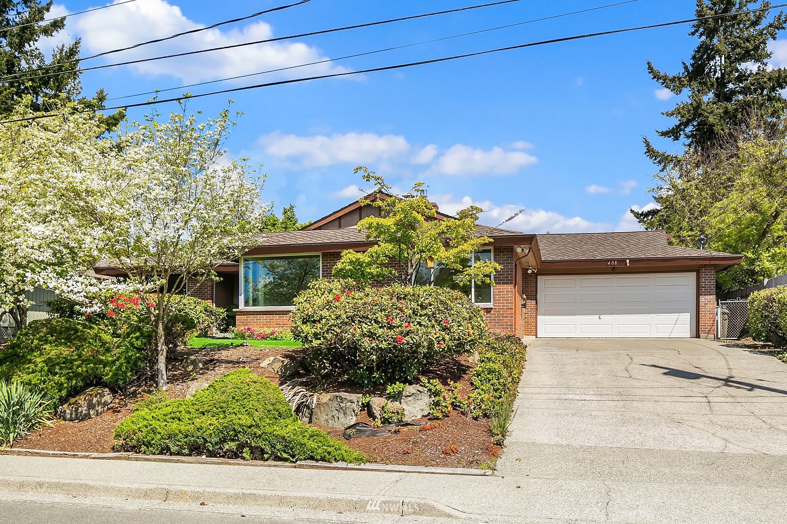 408 Index Place Northeast Renton, WA 98056 - Photo 2 of 31 a front view of a house with garden