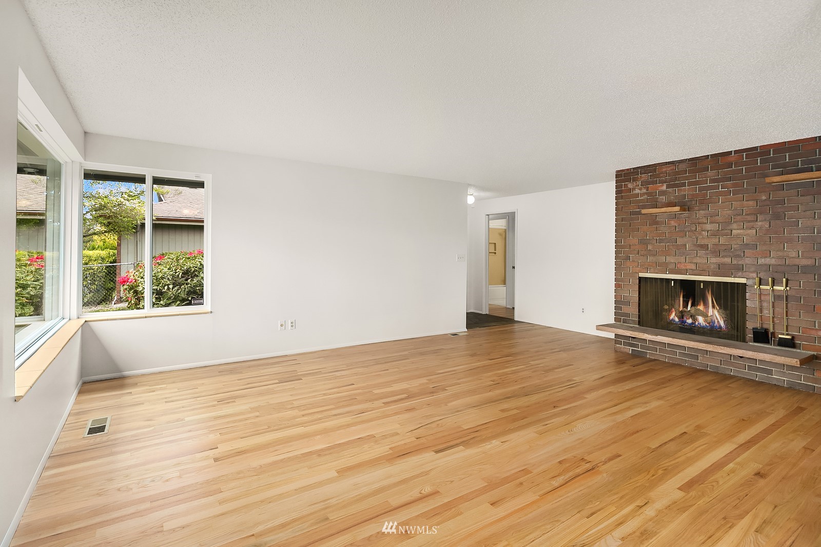 408 Index Place Northeast Renton, WA 98056 - Photo 8 of 31 wooden floor fireplace and windows in an empty room