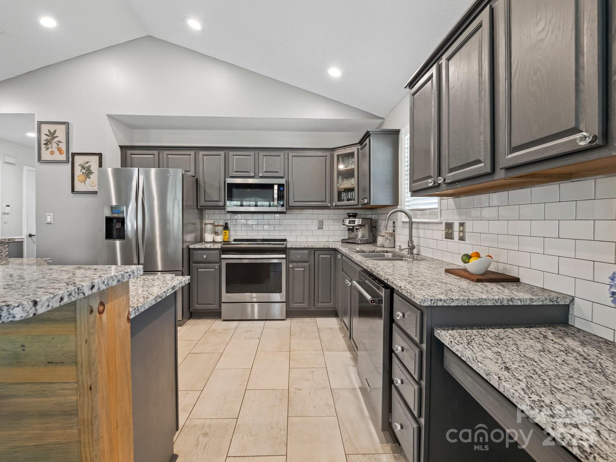 10 Gray Wolf Lane Hendersonville, NC 28792 - Photo 12 of 42 a kitchen with stainless steel appliances granite countertop a sink stove microwave and refrigerator