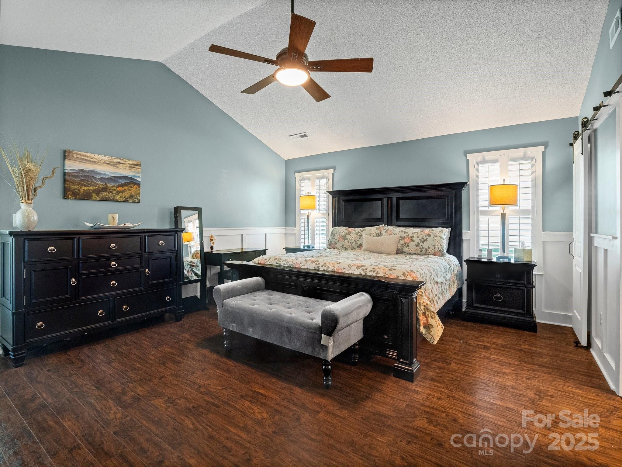 10 Gray Wolf Lane Hendersonville, NC 28792 - Photo 22 of 42 a bedroom with a bed and a chandelier