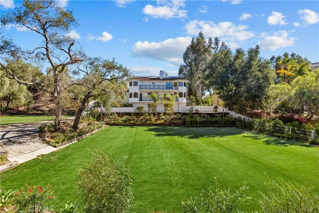 a view of a field of grass and trees
