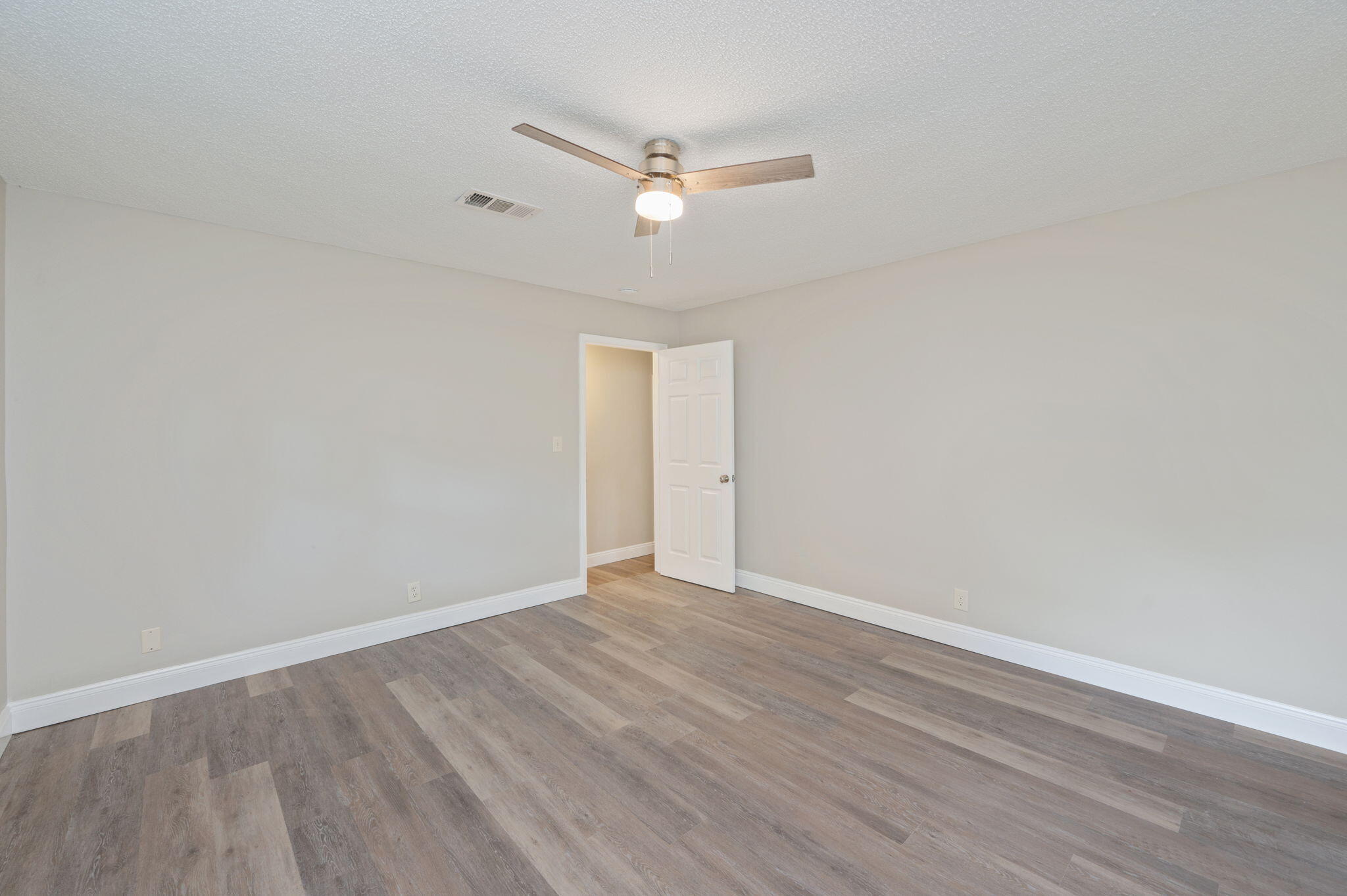 165 Smith Street Crestview, FL 32539 - Photo 14 of 30 a view of an empty room with wooden floor