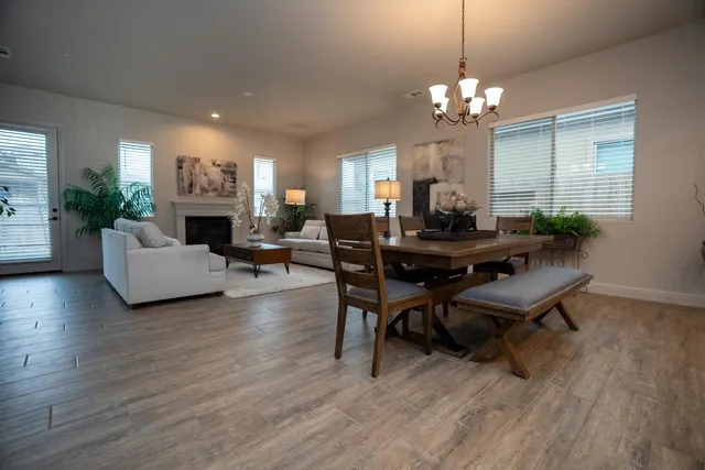 a view of a hallway with wooden floor and a bathroom